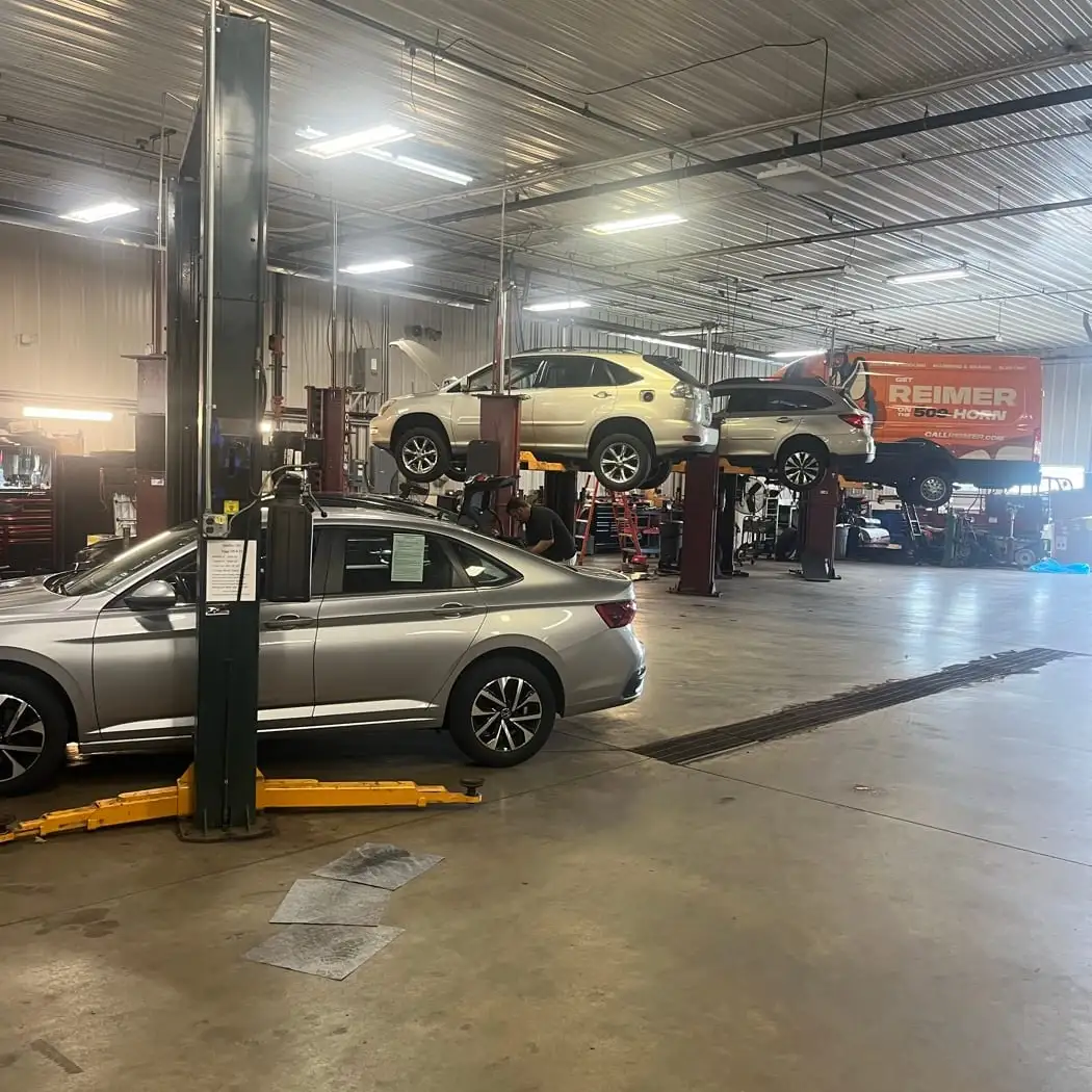 A used SUV on the lift being inspected before purchase