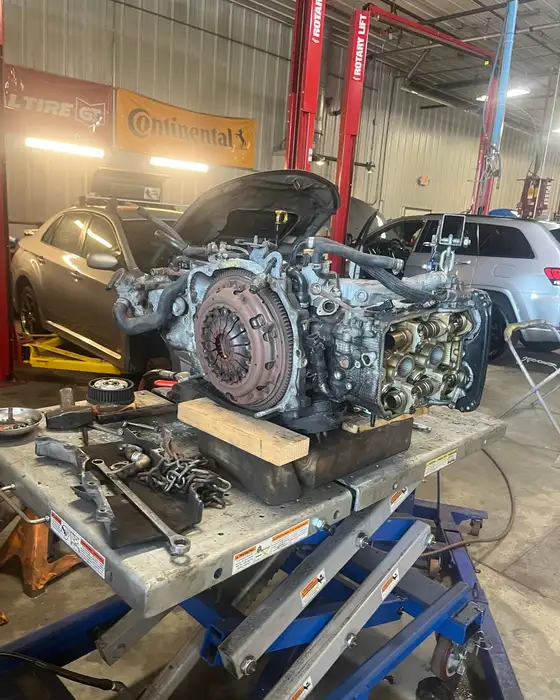 An engine and transmission out on the bench for a drivetrain repair at Fogg's Automotive